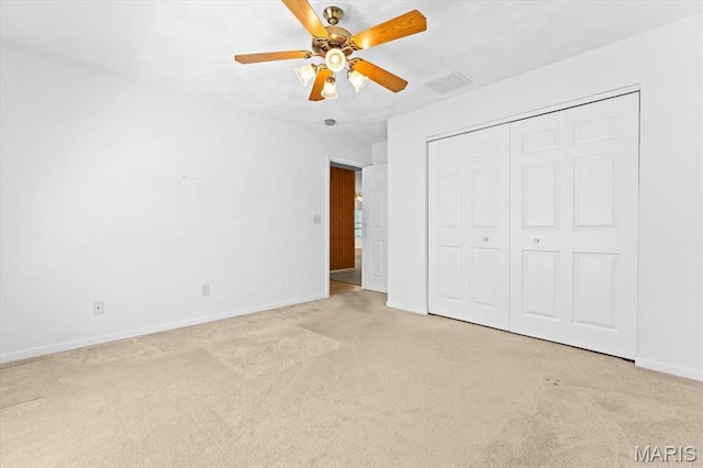 unfurnished bedroom with carpet floors, baseboards, a closet, and ceiling fan