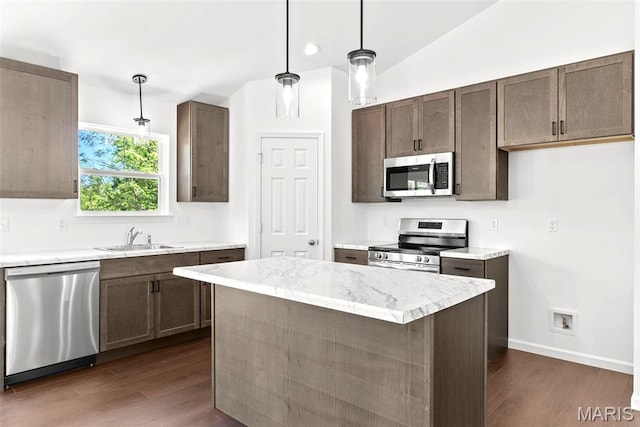 1909 Magnolia Way, Pevely, MO 63070 - kitchen featuring stainless steel appliances, dark wood finished floors, hanging light fixtures, a center island, and dark brown cabinets