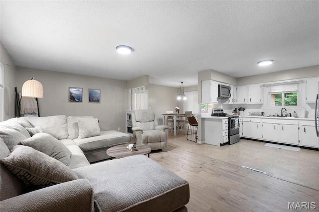 804 Harvard St, Sikeston, MO 63801 - living room with a textured ceiling and light wood finished floors
