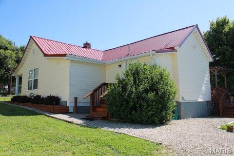 205 Watts St, Park Hills, MO 63601 - view of side of property with a chimney, a yard, and metal roof