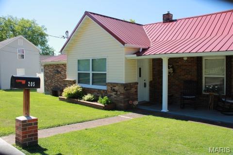 205 Watts St, Park Hills, MO 63601 - view of front of house with a standing seam roof, a chimney, a front lawn, and metal roof
