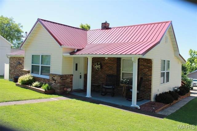 205 Watts St, Park Hills, MO 63601 - view of front of property featuring a chimney, a front lawn, covered porch, a standing seam roof, and metal roof
