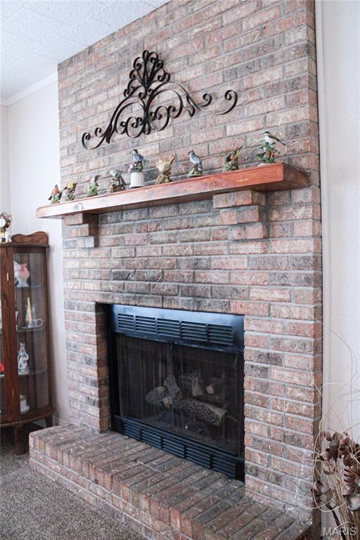 205 Watts St, Park Hills, MO 63601 - detailed view of a fireplace, crown molding, and carpet flooring