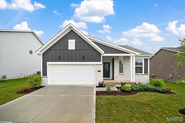 719 Myatt Dr, Wentzville, MO 63385 - view of front facade featuring brick siding, board and batten siding, driveway, and a front lawn