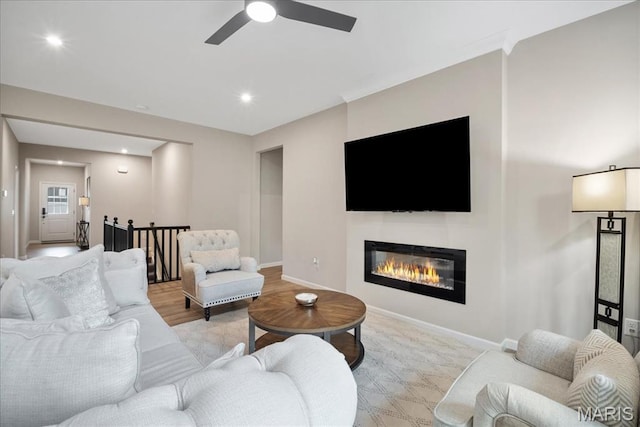 719 Myatt Dr, Wentzville, MO 63385 - living area with a ceiling fan, a glass covered fireplace, and recessed lighting