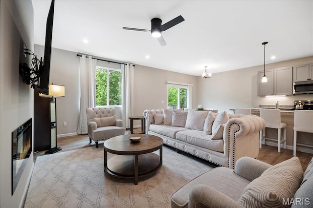 719 Myatt Dr, Wentzville, MO 63385 - living room with light wood finished floors, recessed lighting, a ceiling fan, and a chandelier