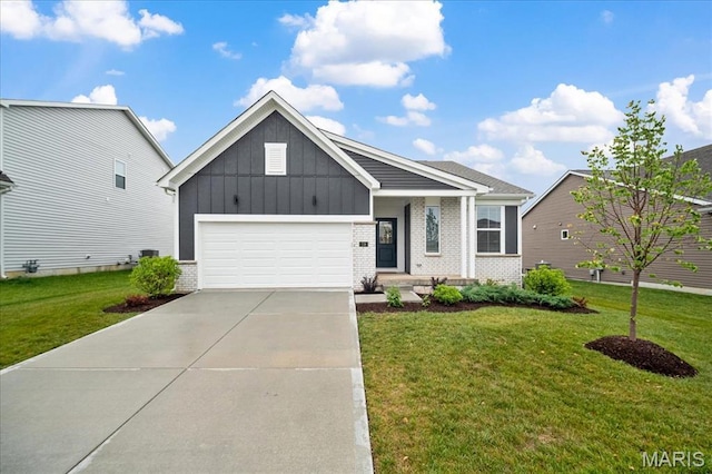 719 Myatt Dr, Wentzville, MO 63385 - view of front of property with board and batten siding, brick siding, a garage, driveway, and a front lawn
