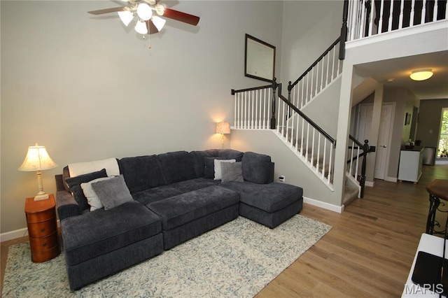 1209 Hunters Chase Dr, Eureka, MO 63025 - living room featuring wood finished floors, a ceiling fan, baseboards, and stairway