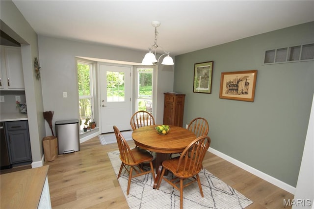 1209 Hunters Chase Dr, Eureka, MO 63025 - dining room with light wood finished floors, baseboards, and a chandelier