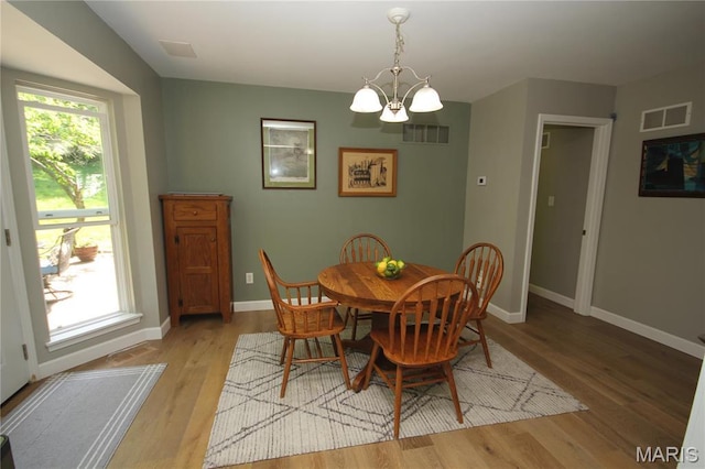 1209 Hunters Chase Dr, Eureka, MO 63025 - dining space featuring a chandelier, light wood-style flooring, and baseboards