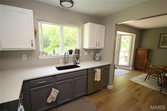 1209 Hunters Chase Dr, Eureka, MO 63025 - kitchen featuring a sink, stainless steel dishwasher, light wood-type flooring, white cabinets, and gray cabinets