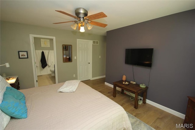1209 Hunters Chase Dr, Eureka, MO 63025 - bedroom featuring wood finished floors, baseboards, ensuite bath, and a ceiling fan