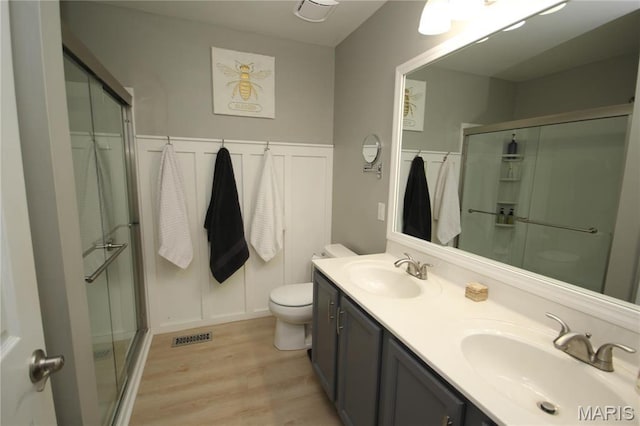 1209 Hunters Chase Dr, Eureka, MO 63025 - full bathroom with wood finished floors, a stall shower, toilet, and double vanity