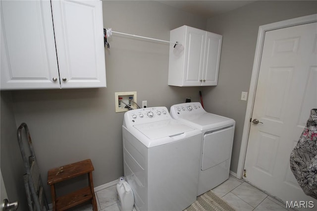 1209 Hunters Chase Dr, Eureka, MO 63025 - laundry area featuring cabinet space, washing machine and dryer, baseboards, and light tile patterned floors