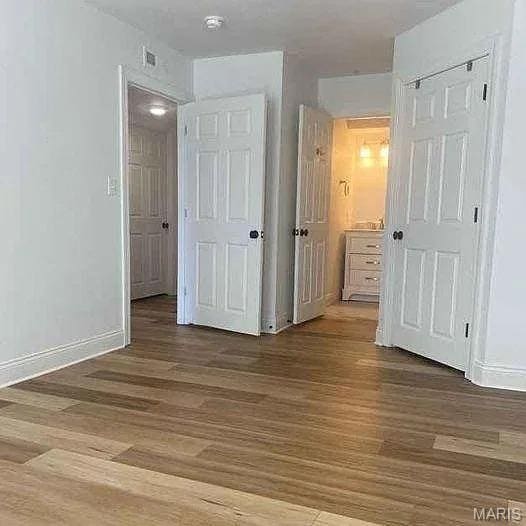 14 Homefield Gardens Dr Unit 19N, Ofallon, MO 63366 - unfurnished bedroom featuring wood finished floors and baseboards
