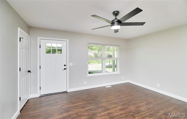 entrance foyer with dark wood-type flooring, baseboards, and ceiling fan