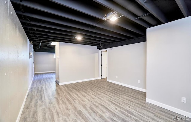 finished below grade area with wood finished floors and baseboards