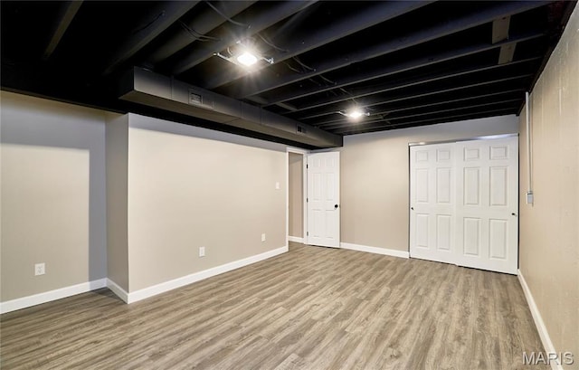 finished below grade area with wood finished floors and baseboards