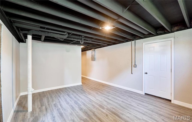 finished below grade area with wood finished floors and baseboards