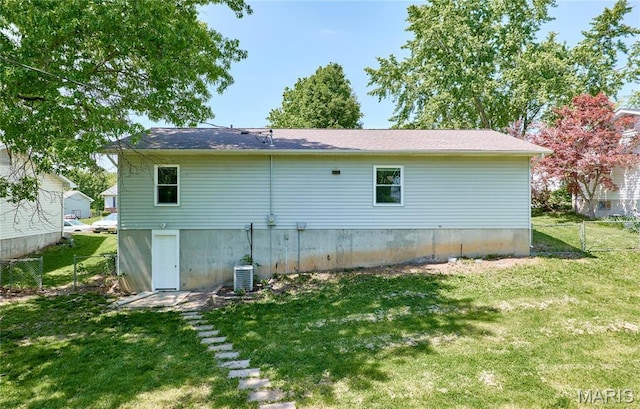 rear view of house featuring central AC