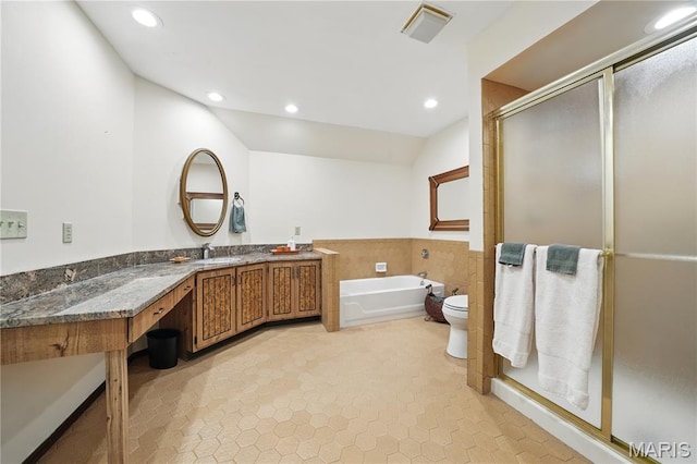 full bathroom with a stall shower, a garden tub, vanity, recessed lighting, and toilet