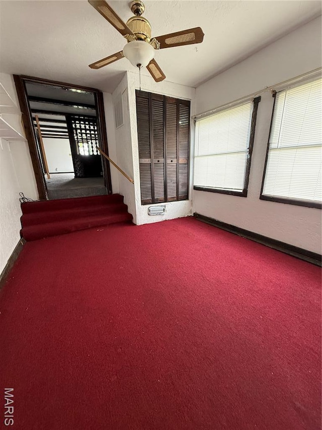 226 Dixie St, Sikeston, MO 63801 - carpeted empty room featuring plenty of natural light, ceiling fan, and stairs