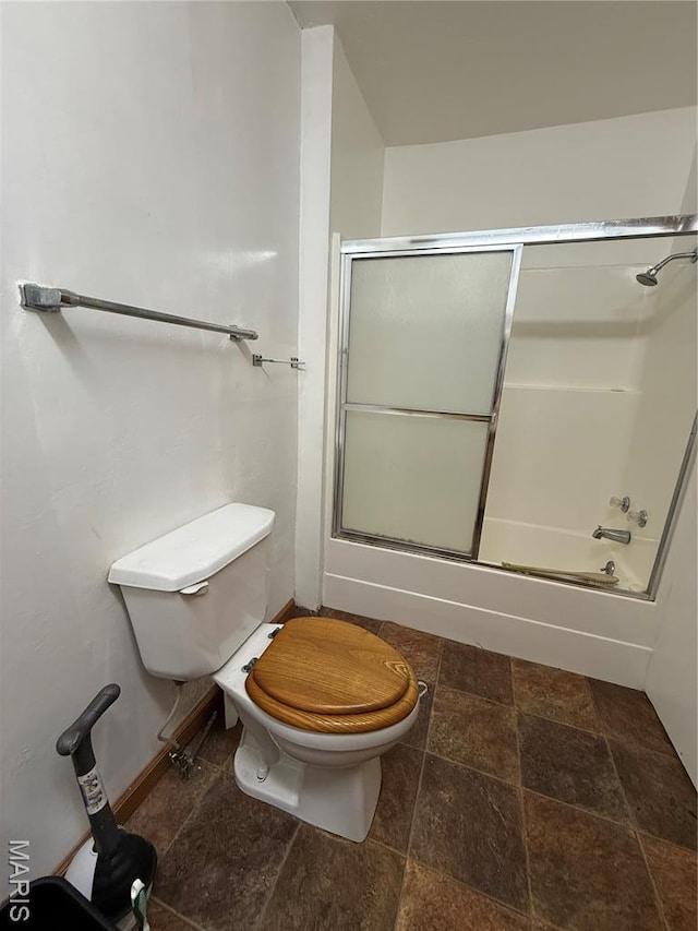 226 Dixie St, Sikeston, MO 63801 - bathroom with toilet, shower / bath combination with glass door, and stone finish floors