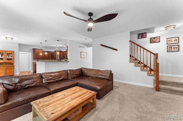 1438 Arbor Green Trl, Ofallon, IL 62269 - living room with ceiling fan, stairs, light carpet, and baseboards