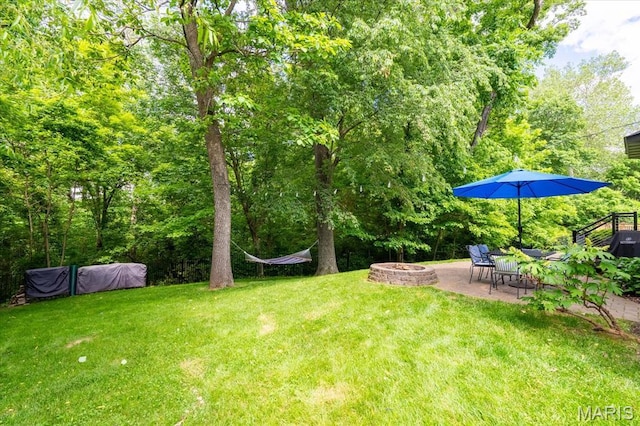 1438 Arbor Green Trl, Ofallon, IL 62269 - view of grassy yard featuring a fire pit and a patio