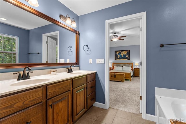 1438 Arbor Green Trl, Ofallon, IL 62269 - ensuite bathroom with double vanity, tile patterned floors, a ceiling fan, a garden tub, and baseboards