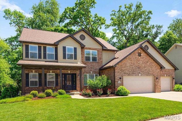 1438 Arbor Green Trl, Ofallon, IL 62269 - view of front of house with an attached garage, concrete driveway, a front lawn, a porch, and brick siding