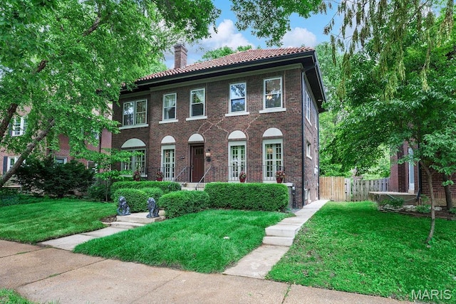 316 Melville Ave, Saint Louis, MO 63130 - colonial inspired home with a chimney, a tile roof, and brick siding