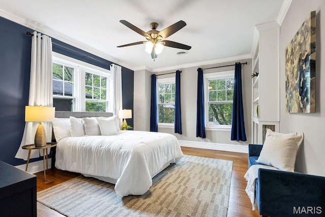 316 Melville Ave, Saint Louis, MO 63130 - bedroom featuring multiple windows, crown molding, wood finished floors, baseboards, and ceiling fan