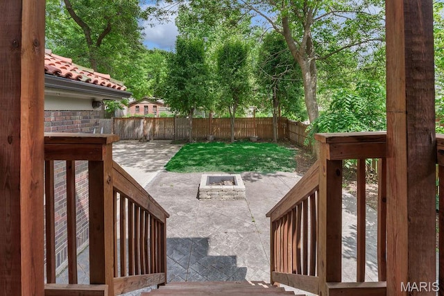316 Melville Ave, Saint Louis, MO 63130 - fenced backyard featuring a fire pit and a patio area