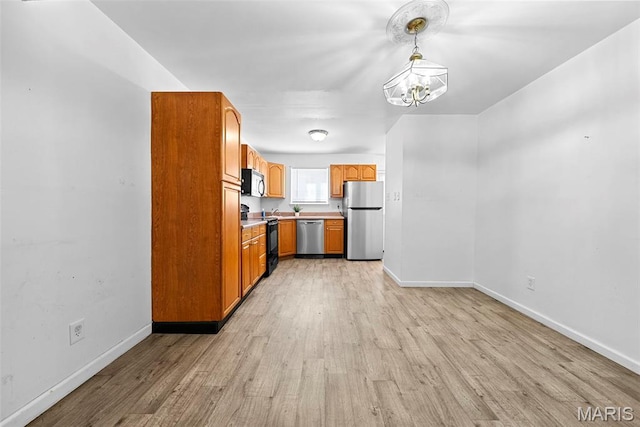 1811 Gascony Parc Dr Unit 1811, Lake St Louis, MO 63367 - kitchen with stainless steel appliances, light wood-style floors, a chandelier, baseboards, and light countertops