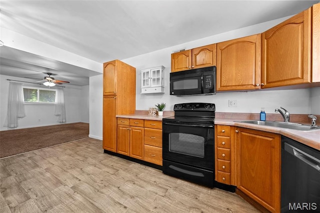 1811 Gascony Parc Dr Unit 1811, Lake St Louis, MO 63367 - kitchen featuring black appliances, a sink, light wood-style floors, light countertops, and ceiling fan