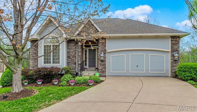 1204 Cobblestone Ter, Lake St Louis, MO 63367 - view of front of property featuring concrete driveway, stone siding, a garage, and a shingled roof