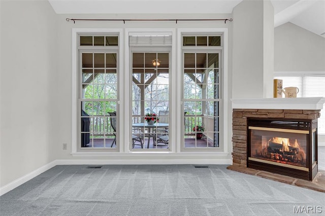 1204 Cobblestone Ter, Lake St Louis, MO 63367 - unfurnished living room with carpet floors, plenty of natural light, a fireplace, lofted ceiling, and baseboards