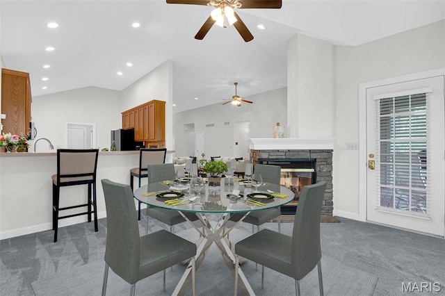 1204 Cobblestone Ter, Lake St Louis, MO 63367 - dining room with ceiling fan, vaulted ceiling, light carpet, recessed lighting, and a stone fireplace