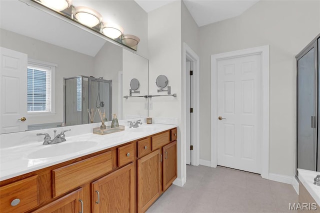 1204 Cobblestone Ter, Lake St Louis, MO 63367 - bathroom featuring a stall shower, double vanity, tile patterned flooring, and baseboards