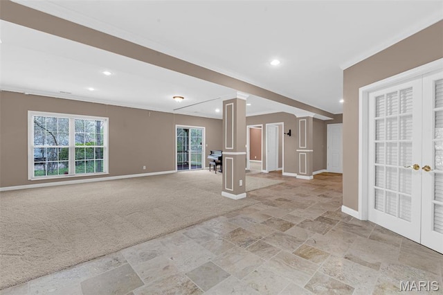 1204 Cobblestone Ter, Lake St Louis, MO 63367 - unfurnished living room featuring baseboards, stone tile floors, light colored carpet, ornate columns, and recessed lighting