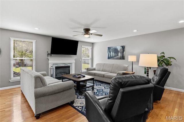 living area with plenty of natural light, ceiling fan, a fireplace, baseboards, and recessed lighting
