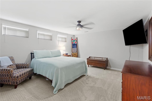 bedroom featuring light carpet and a ceiling fan