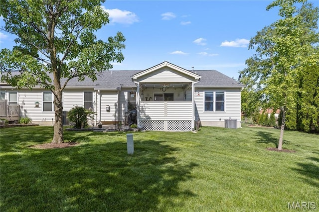 manufactured / mobile home featuring a front lawn and central AC unit