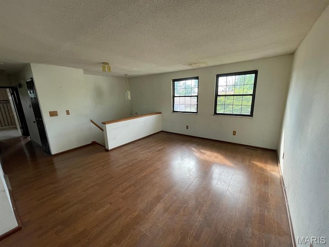 33 Briarcliff Dr, Granite City, IL 62040 - unfurnished room featuring a textured ceiling, dark wood finished floors, and baseboards