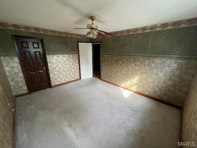 33 Briarcliff Dr, Granite City, IL 62040 - unfurnished bedroom with wallpapered walls, baseboards, carpet floors, and ceiling fan