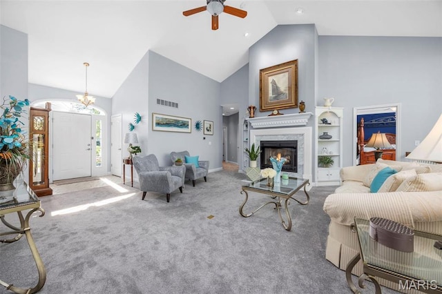 carpeted living area with high vaulted ceiling, a ceiling fan, a lit fireplace, and baseboards