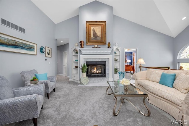 carpeted living room with high vaulted ceiling, a fireplace, built in features, and baseboards