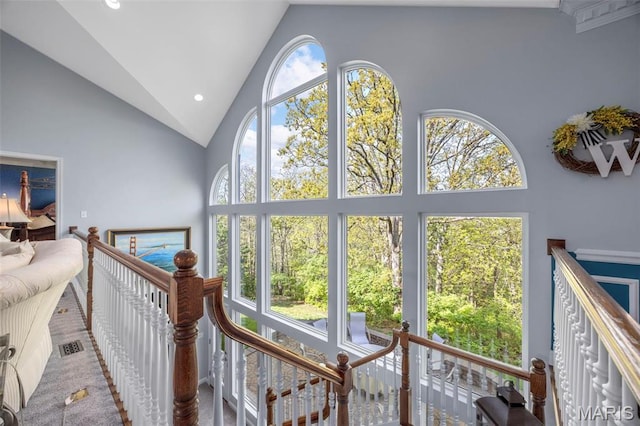 stairway featuring high vaulted ceiling and recessed lighting