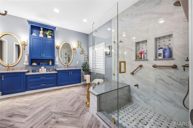 full bathroom featuring a marble finish shower, double vanity, and recessed lighting